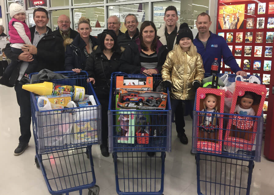 Team shopping for gifts to donate to For the 10